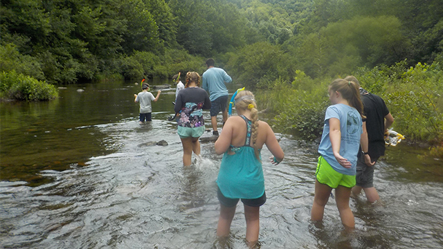 Young people learning about the natural environment. Donate $100 to help shape young lives with the power of outdoor recreation